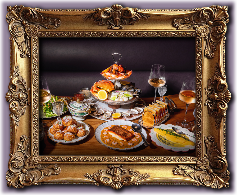 Ornate gilded picture frame with an image of a full tablescape of fancy French food